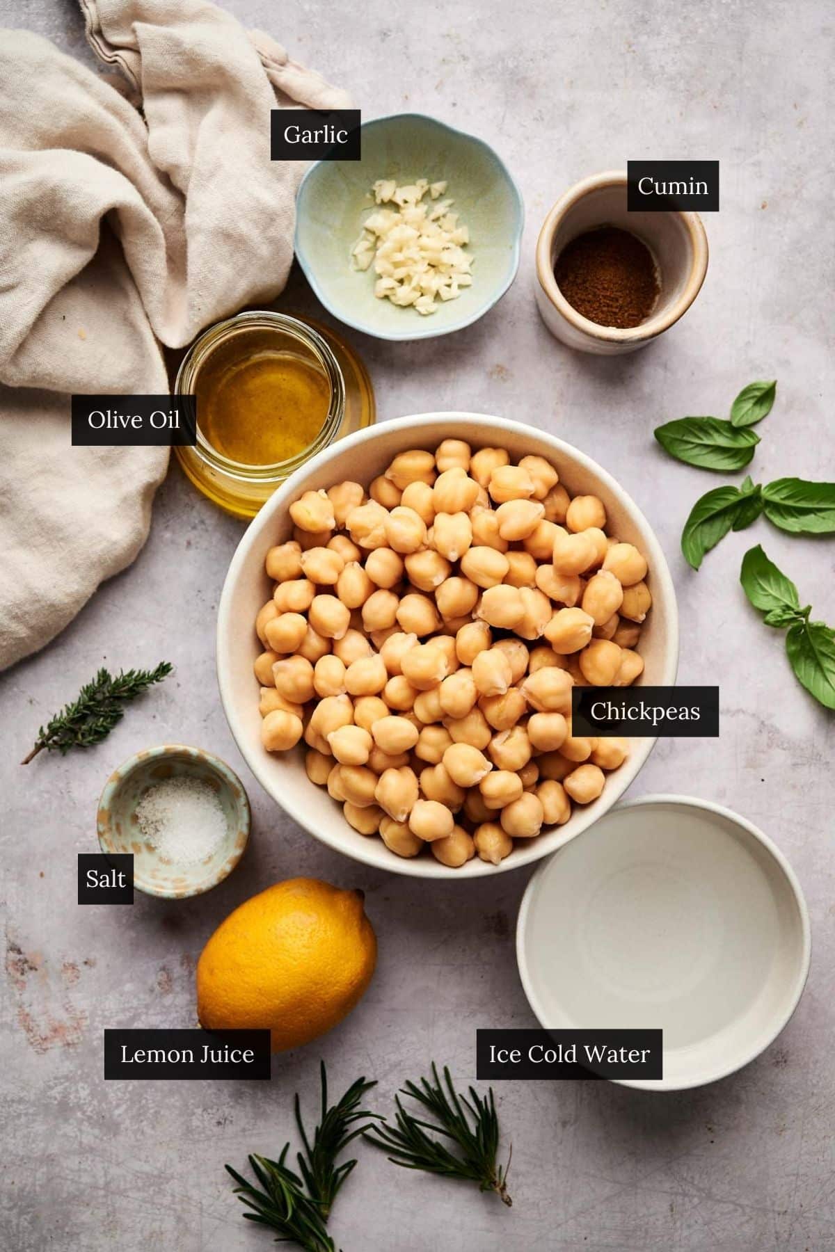 Ingredients for creamy hummus without the tahini with each ingredient labeled.