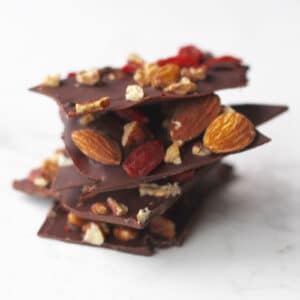 A stack of chocolate bark with nuts and dried fruit.