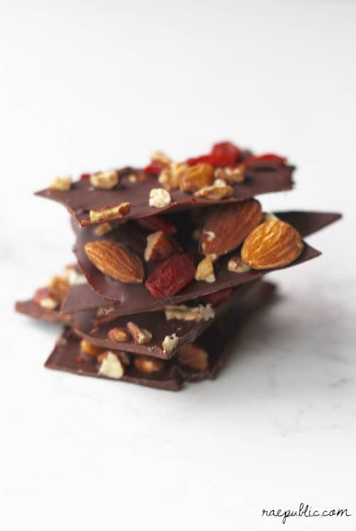A stack of chocolate bark with nuts and dried fruit.