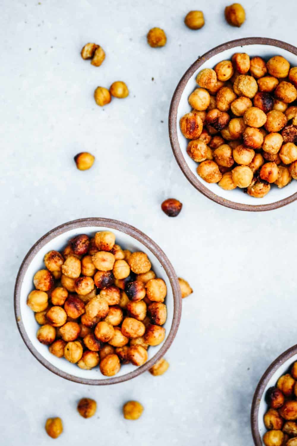 Three bowls of cheesy roasted garbanzo beans.