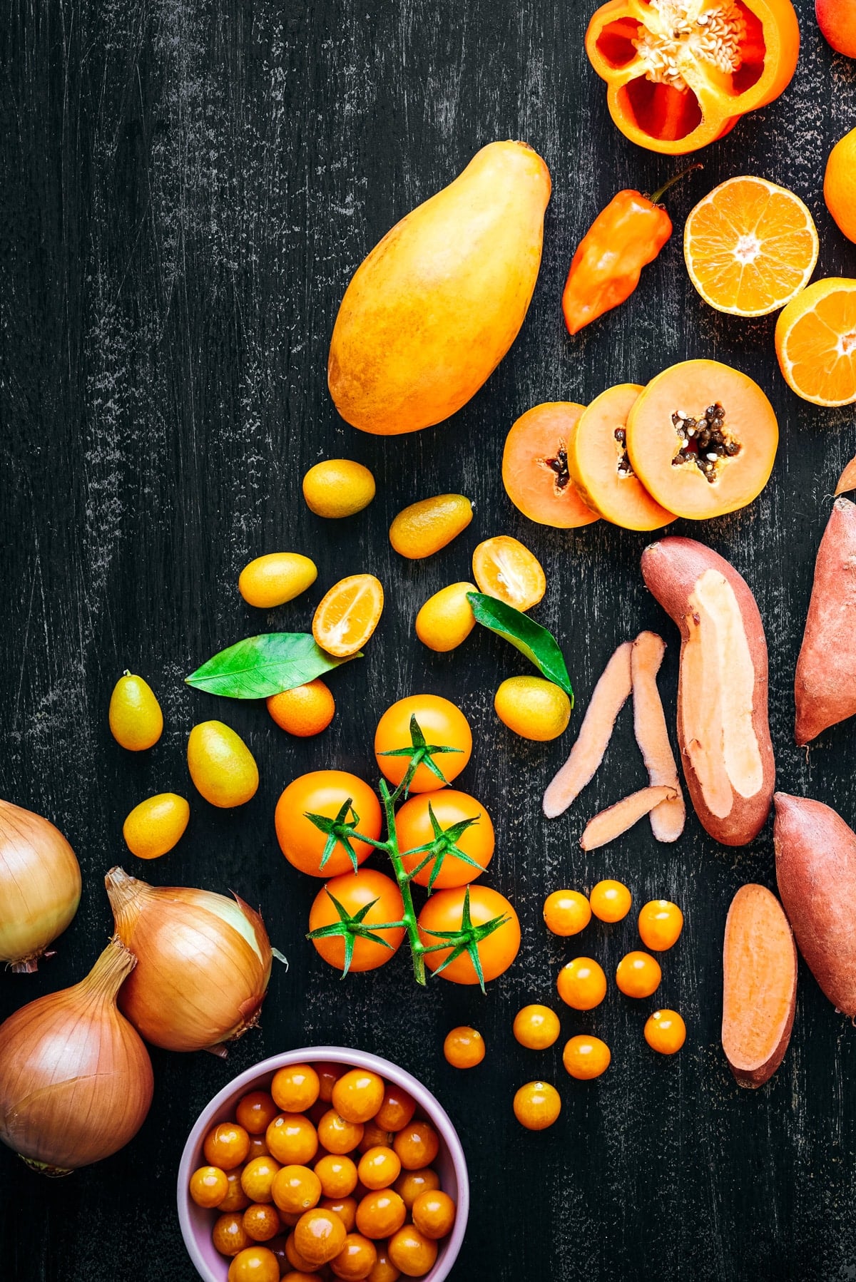 Orange peppers, sweet potatoes, tomatoes and more orange fruit and vegetables.