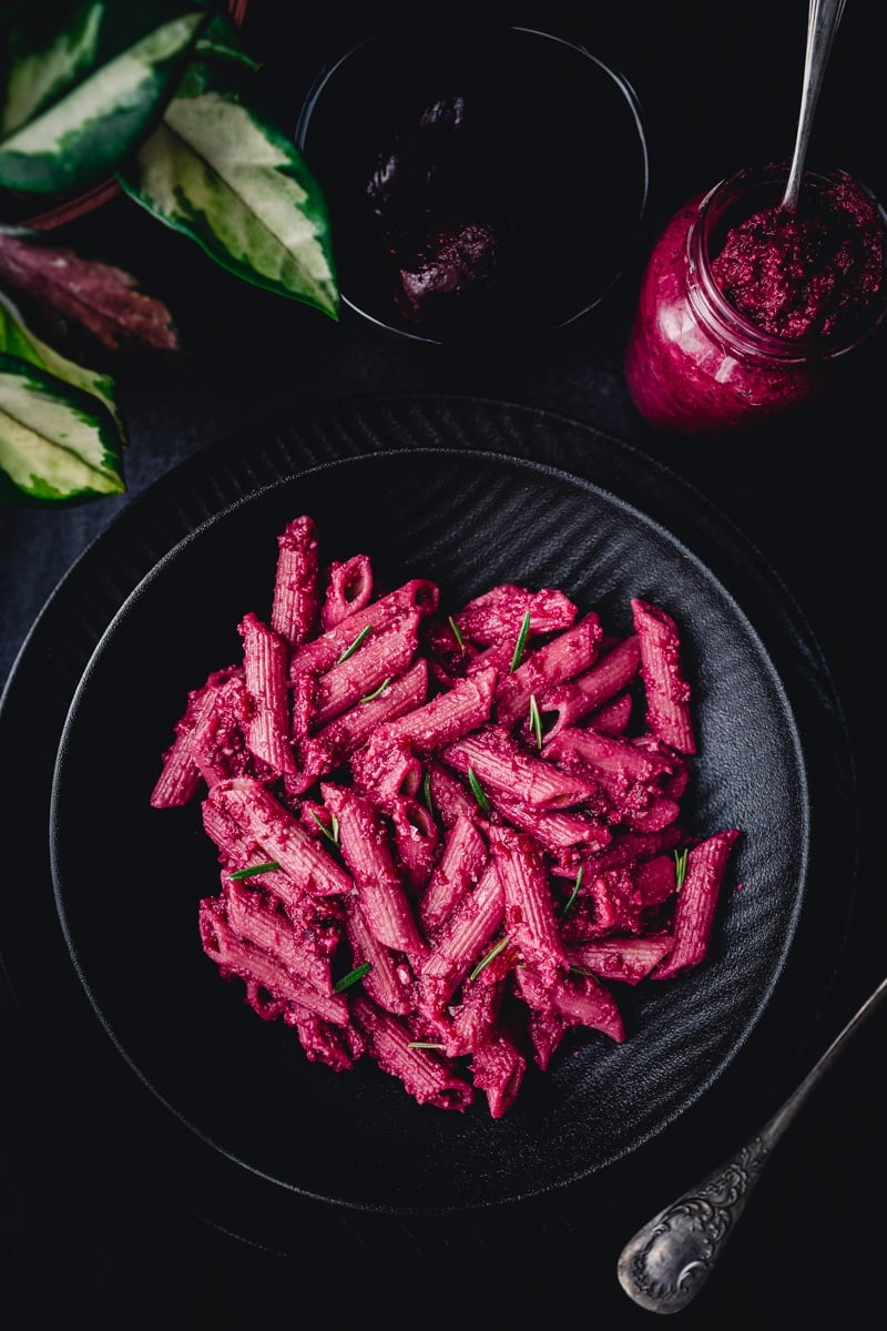Black plate of pink noodles.