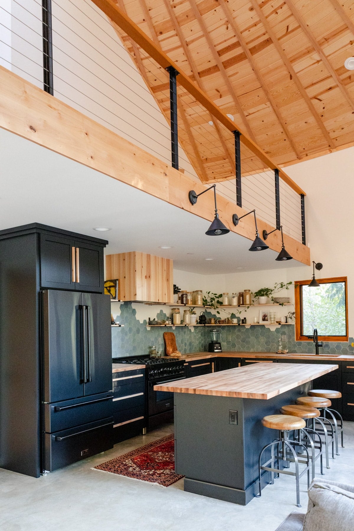 Overall photo of Raepublic's yurt kitchen with pine tongue and groove vaulted ceiling.
