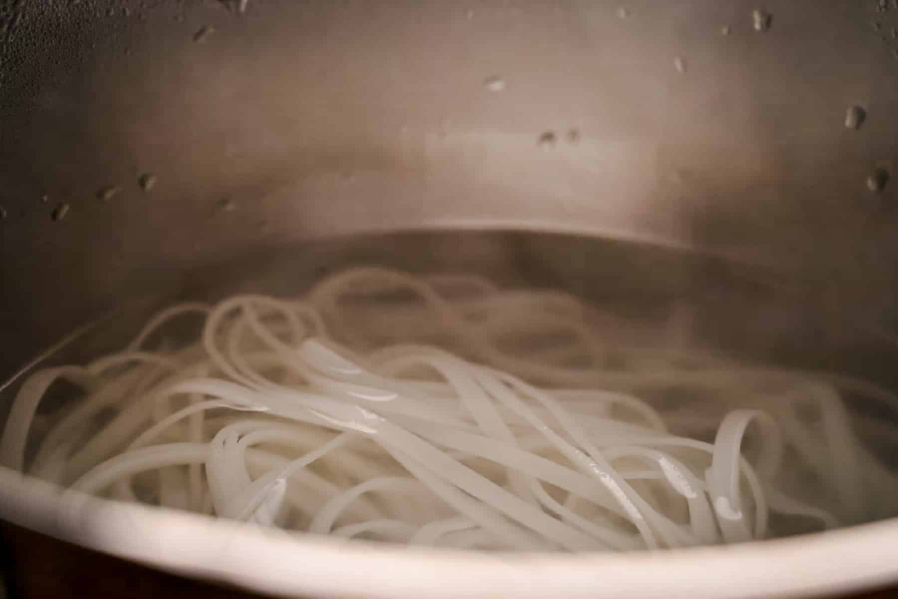 Large pot of rice noodles cooking.