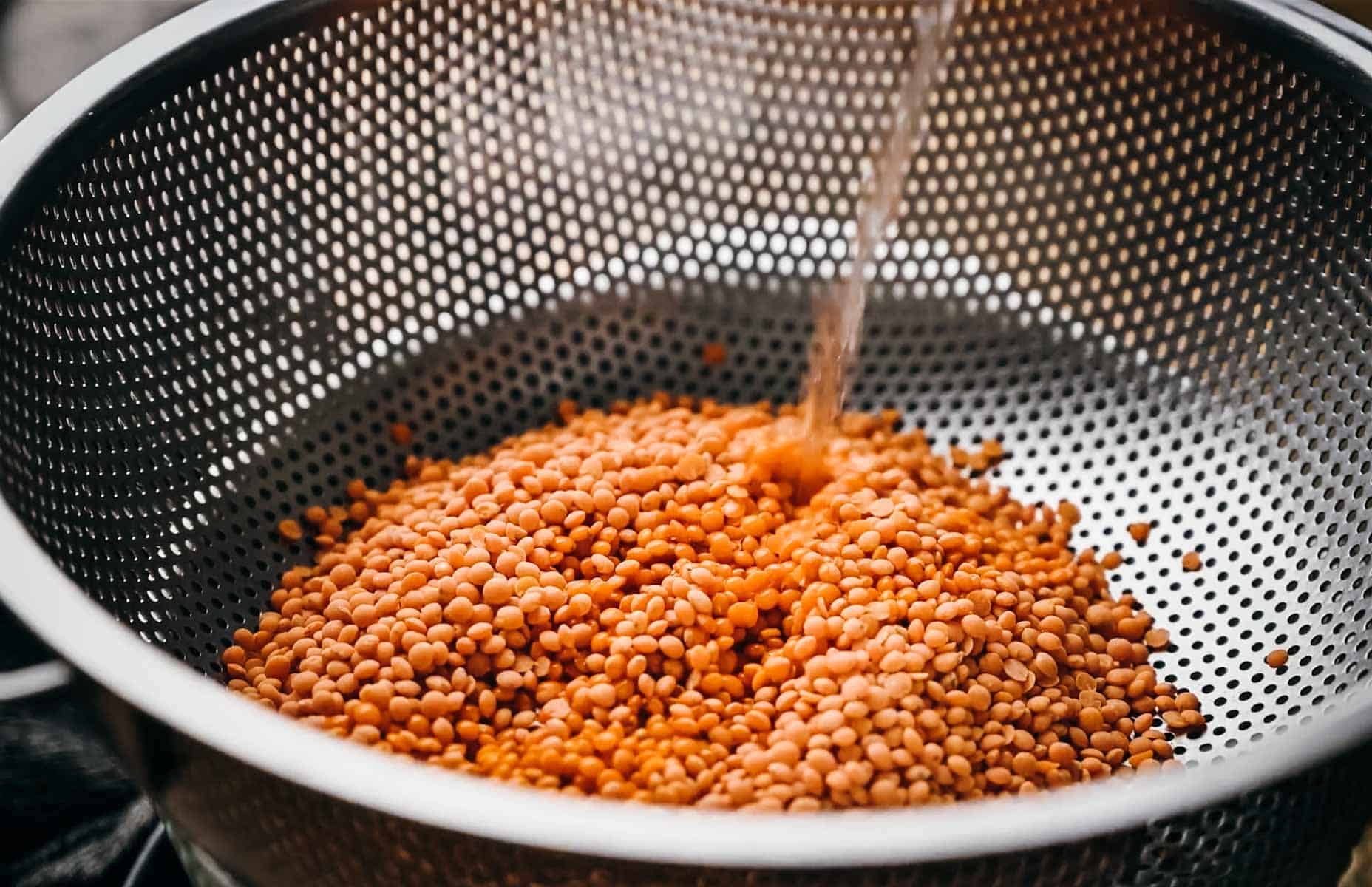 Rinsing red lentils.
