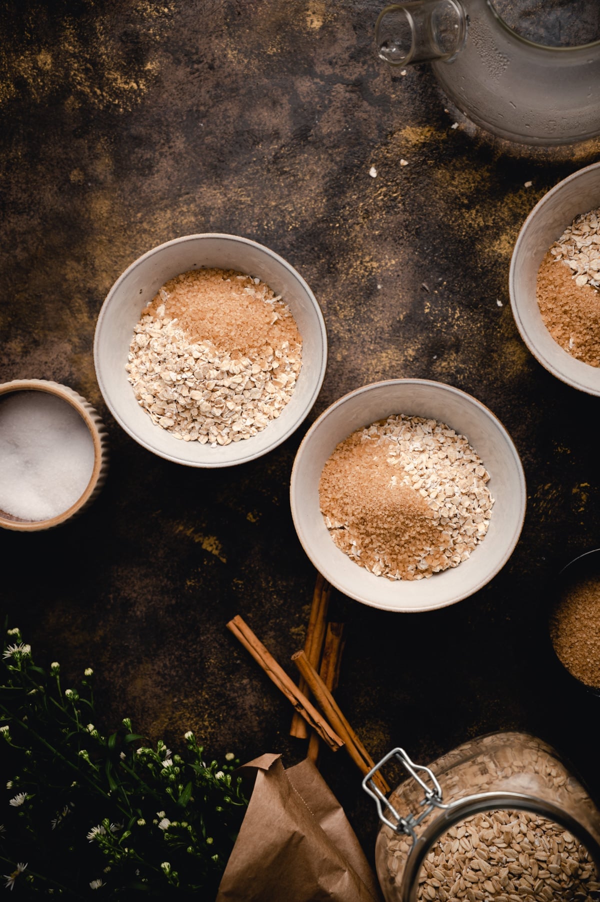 Two bowls of rolled oats with brown sugar on top.