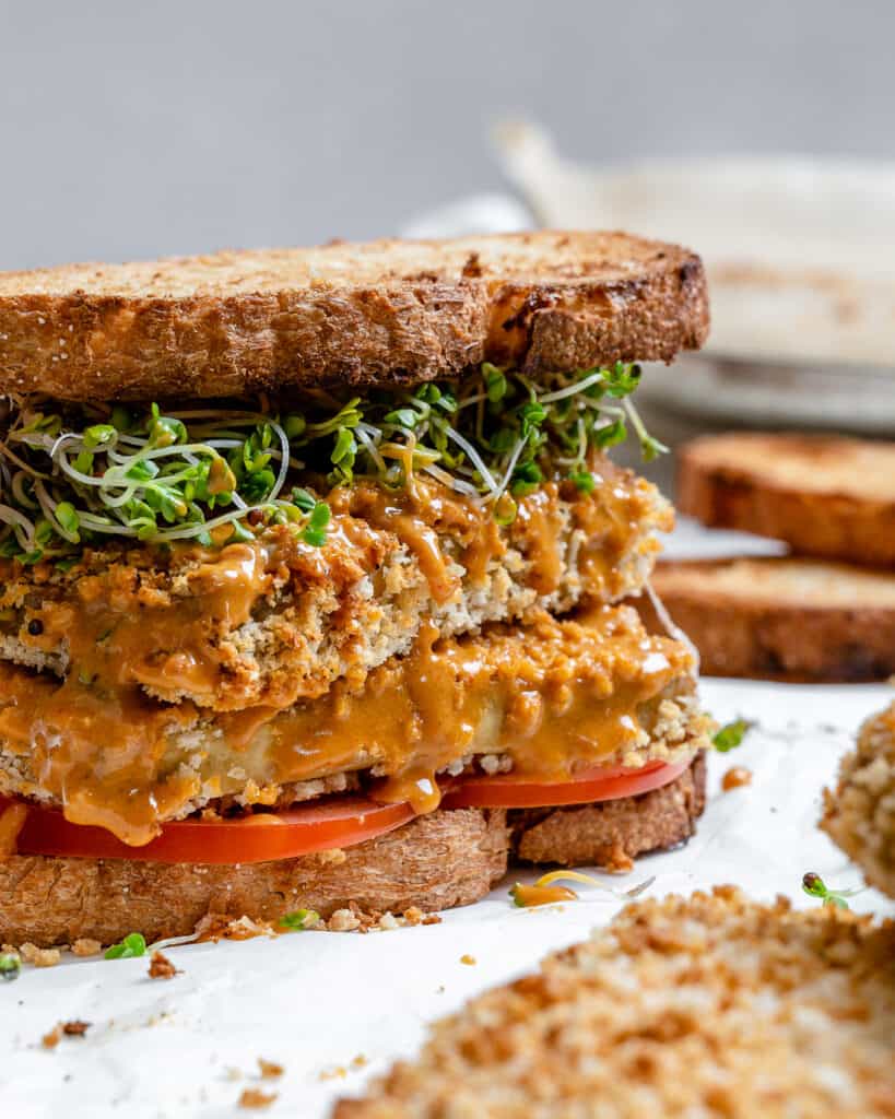 A stack of tofu vegan burgers on a plate.