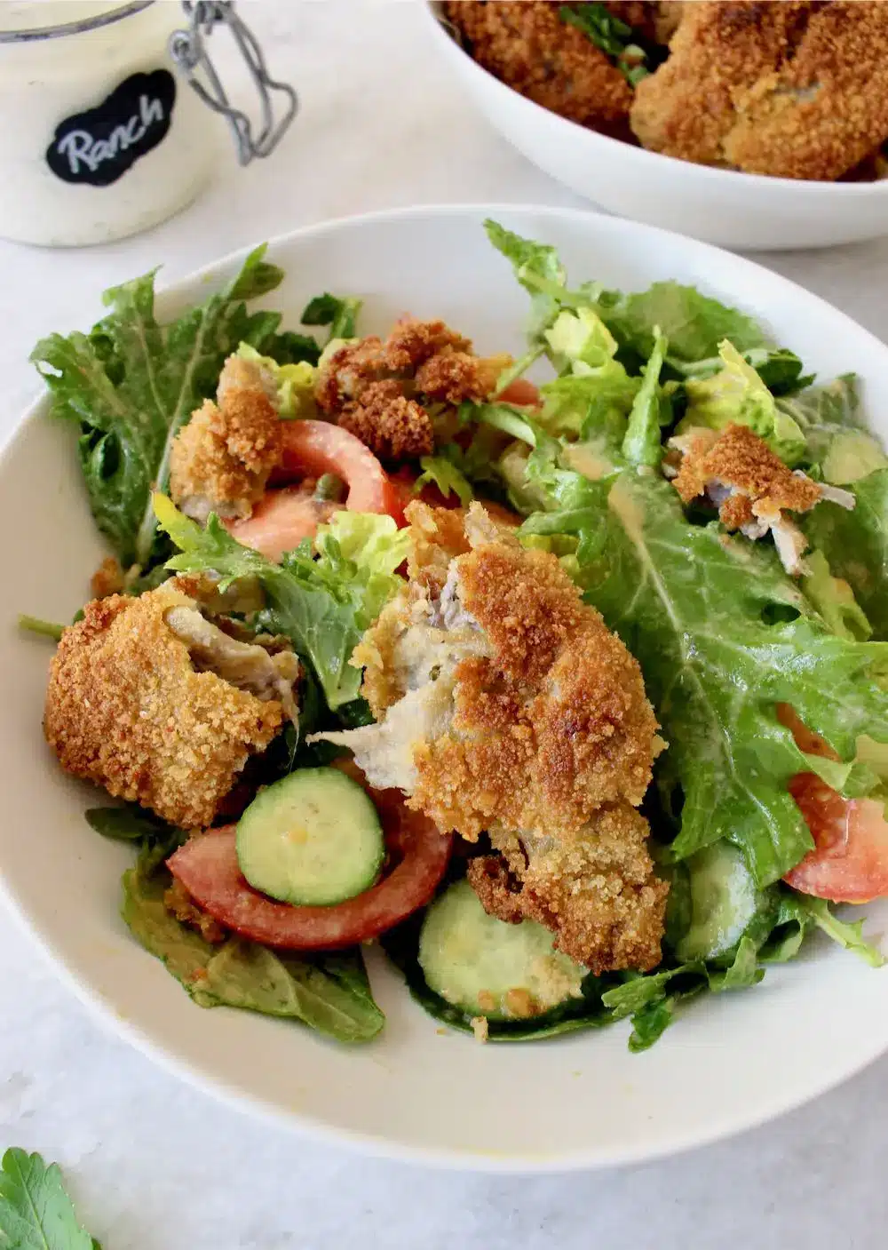 Bowl of jackfruit fried "chicken" on a bed of greens.
