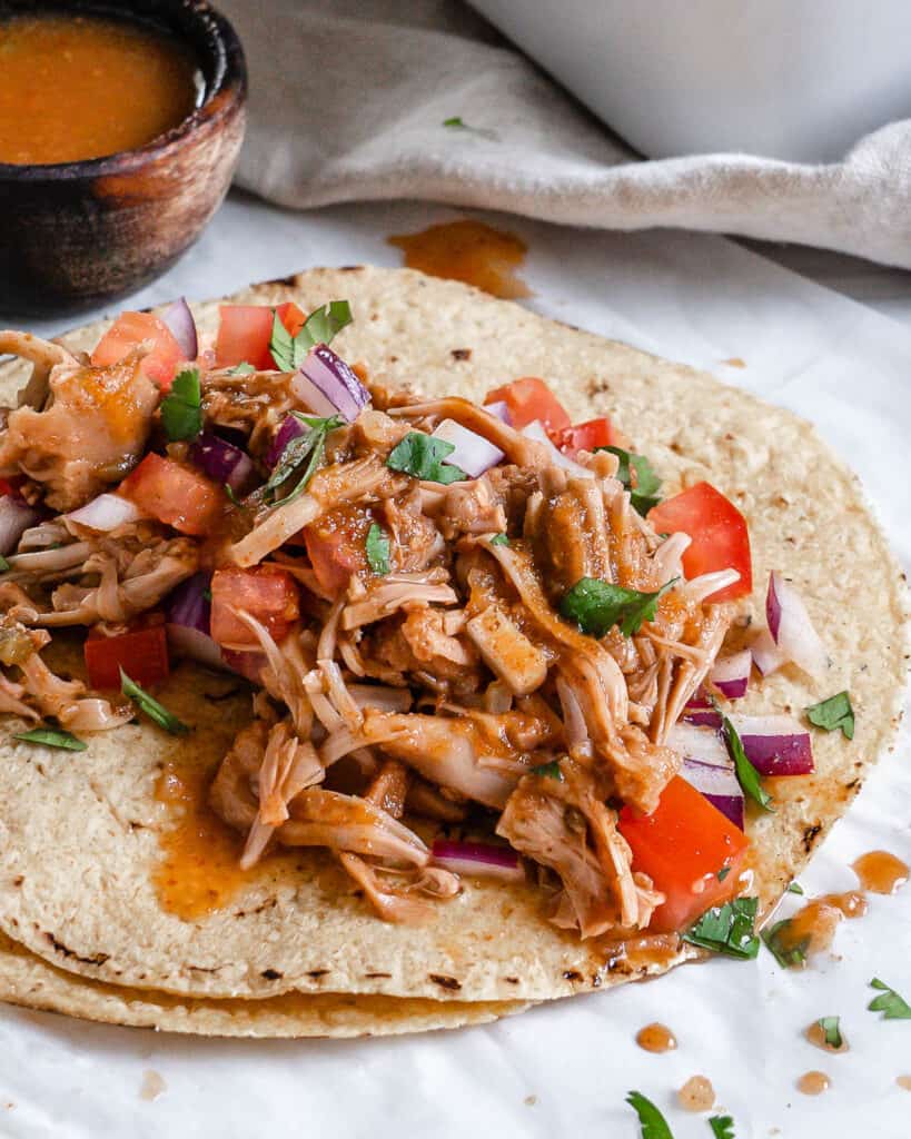 Flat tortilla with seasoned jackfruit, diced tomatoes, and onions.