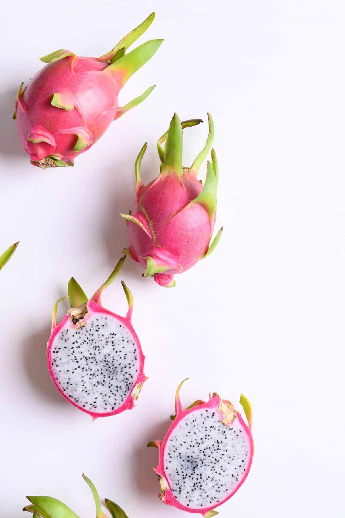 Pink skinned dragon fruit with white flesh and tiny black seeds.