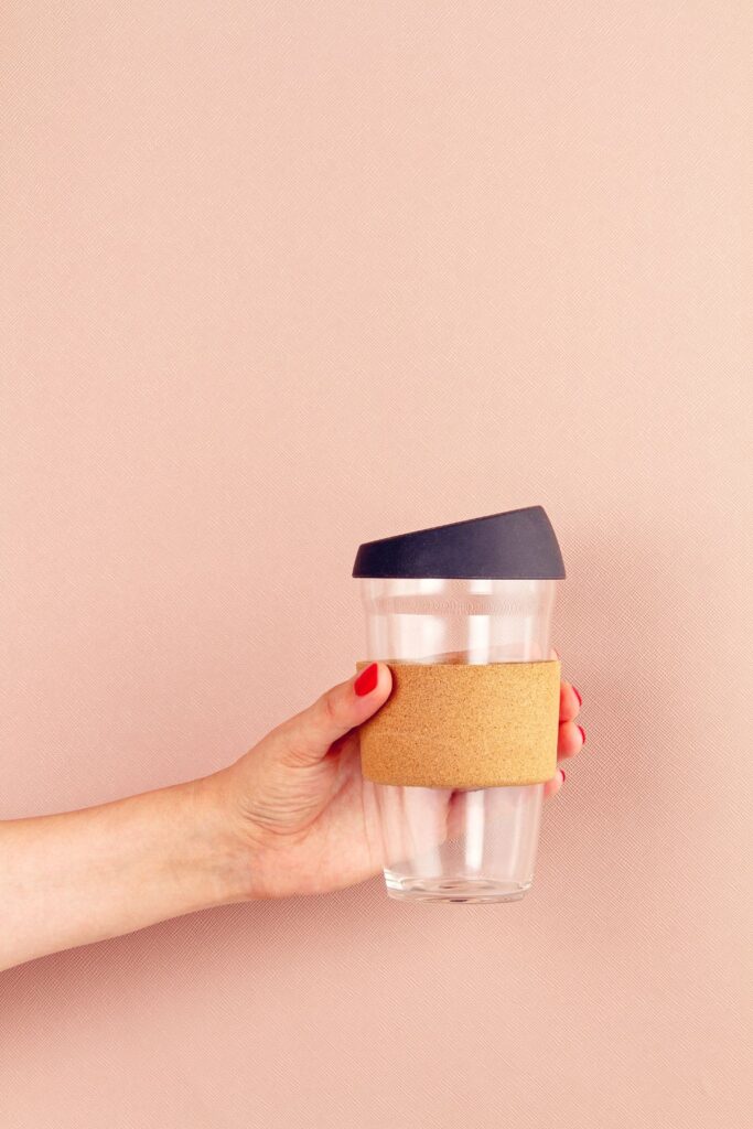 Woman holding reusable travel mug.