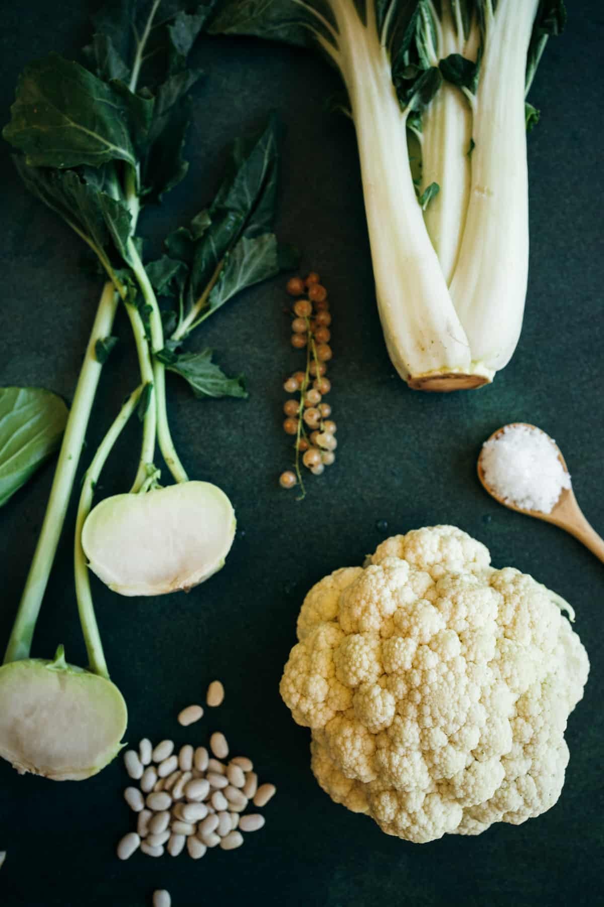 Foods that are white including cauliflower, white great northern beans, sea salt, and giant bok choy.