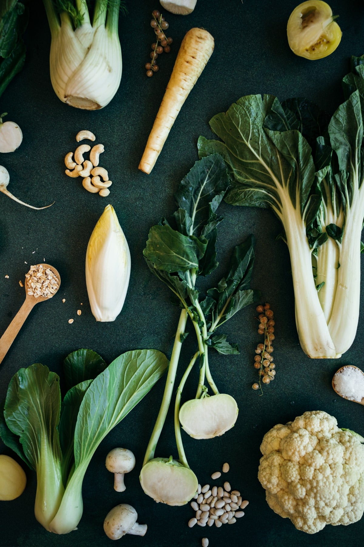 White fruits and vegetables with vibrant green leaves.