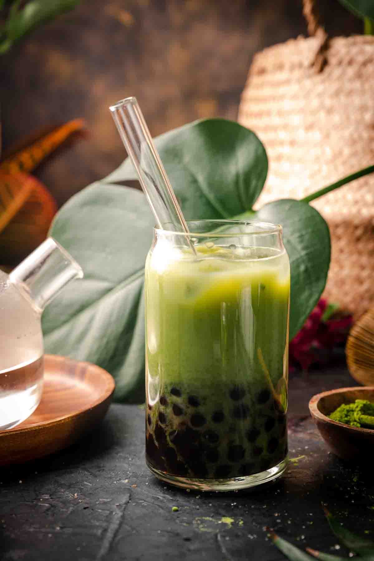 Matcha boba tea latte with tapioca pearls in the bottom.