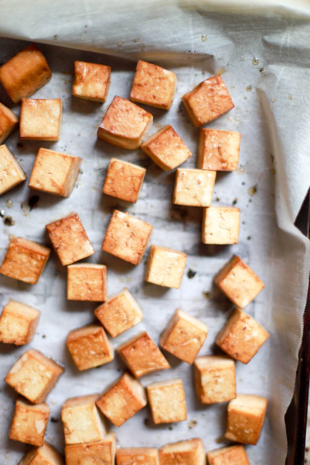 Tofu cubes on a baking sheet.