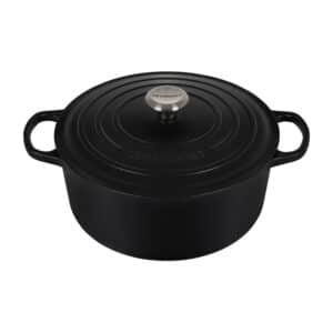 A black cast iron dutch oven on a white background.