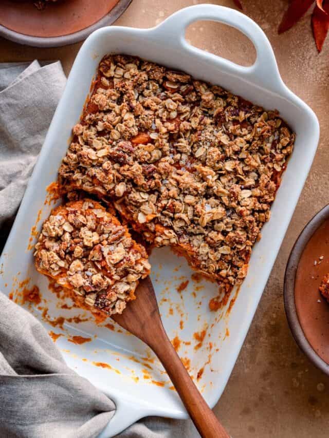 A white dish with a piece of sweet potato casserole.