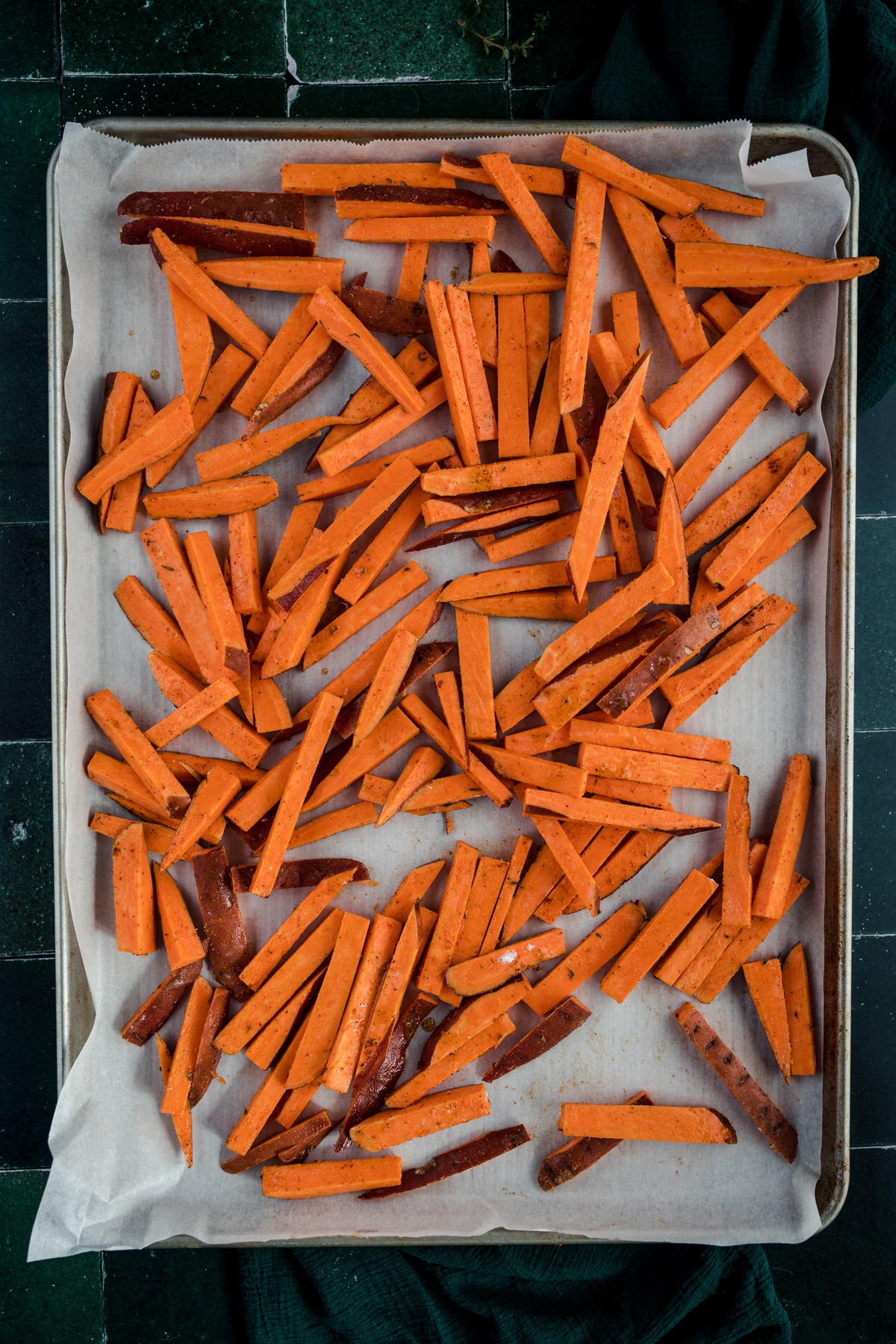 Sweet potato fries on a baking sheet.