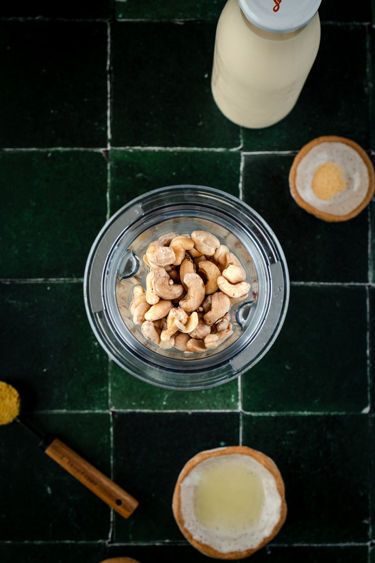 Soaked cashews added to a blender cup.