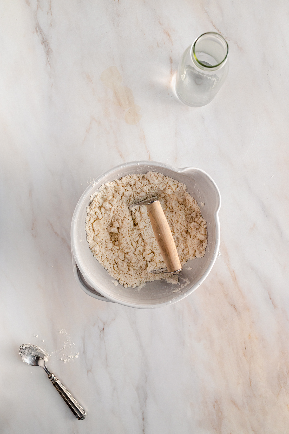 A white bowl on a marble table.