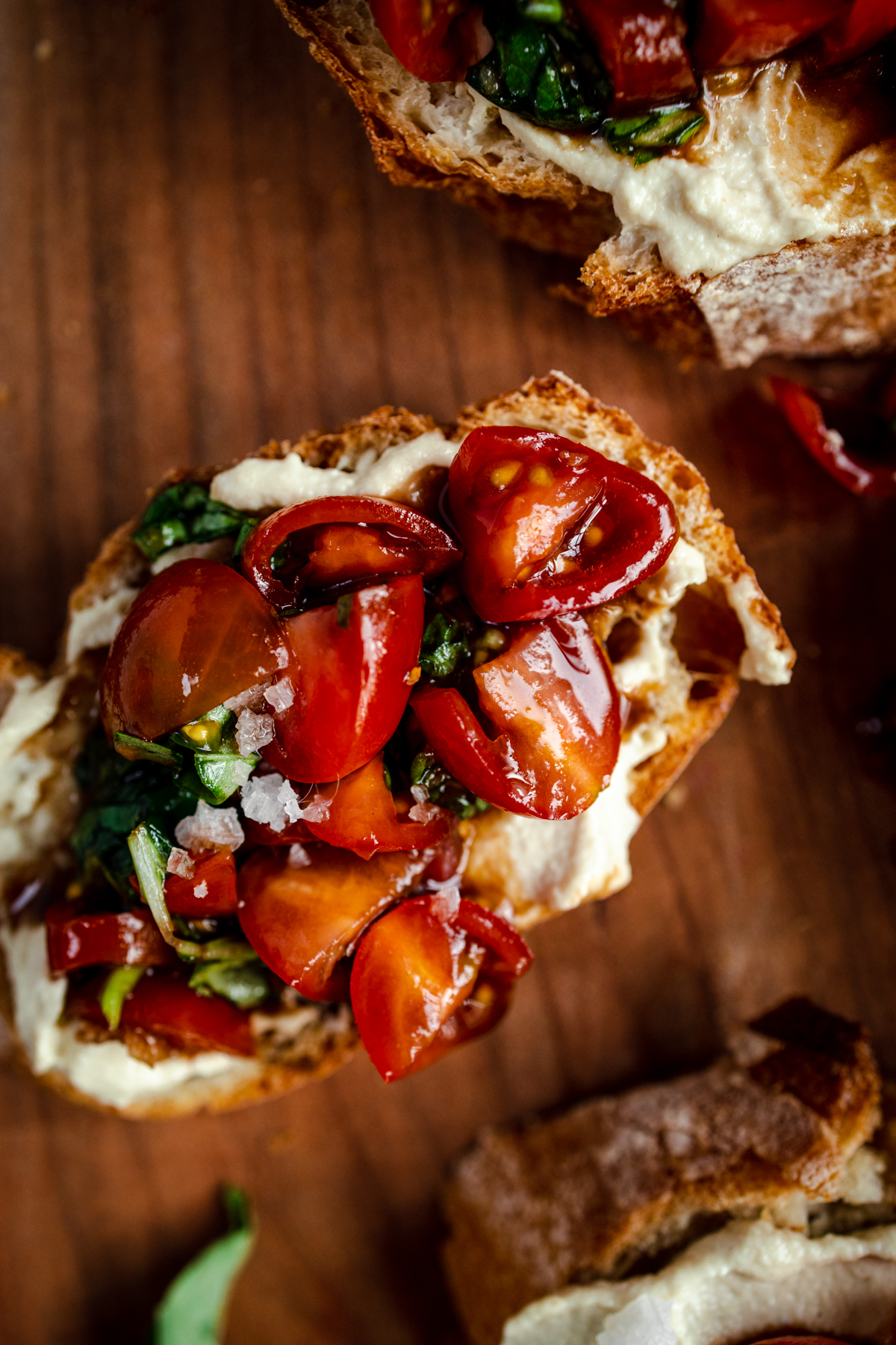 Bruschetta with tomatoes and basil on a wooden board.