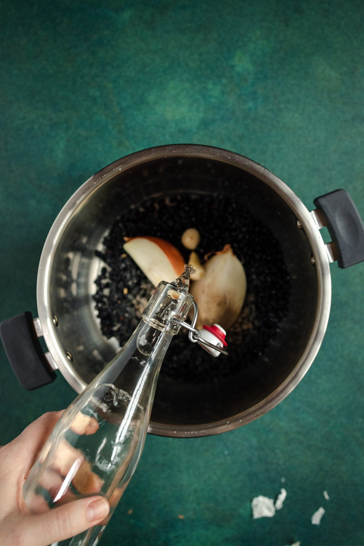 A person pouring water into a pot.