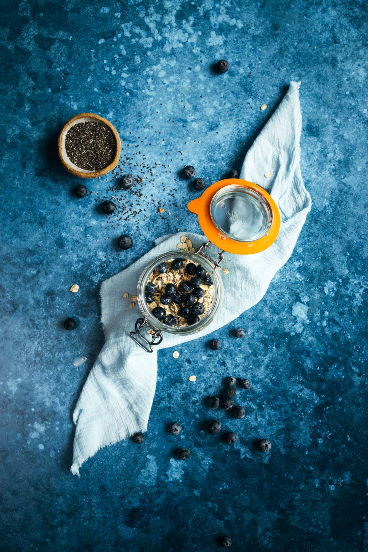 Blueberries on chia overnight oats in a Le Parfait mason jar.