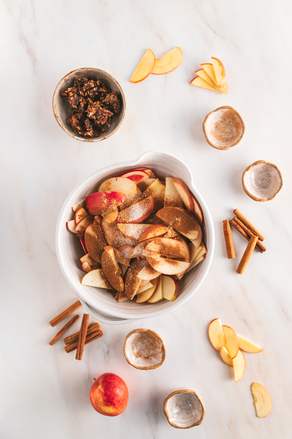 Apple chips in a bowl on a marble table.