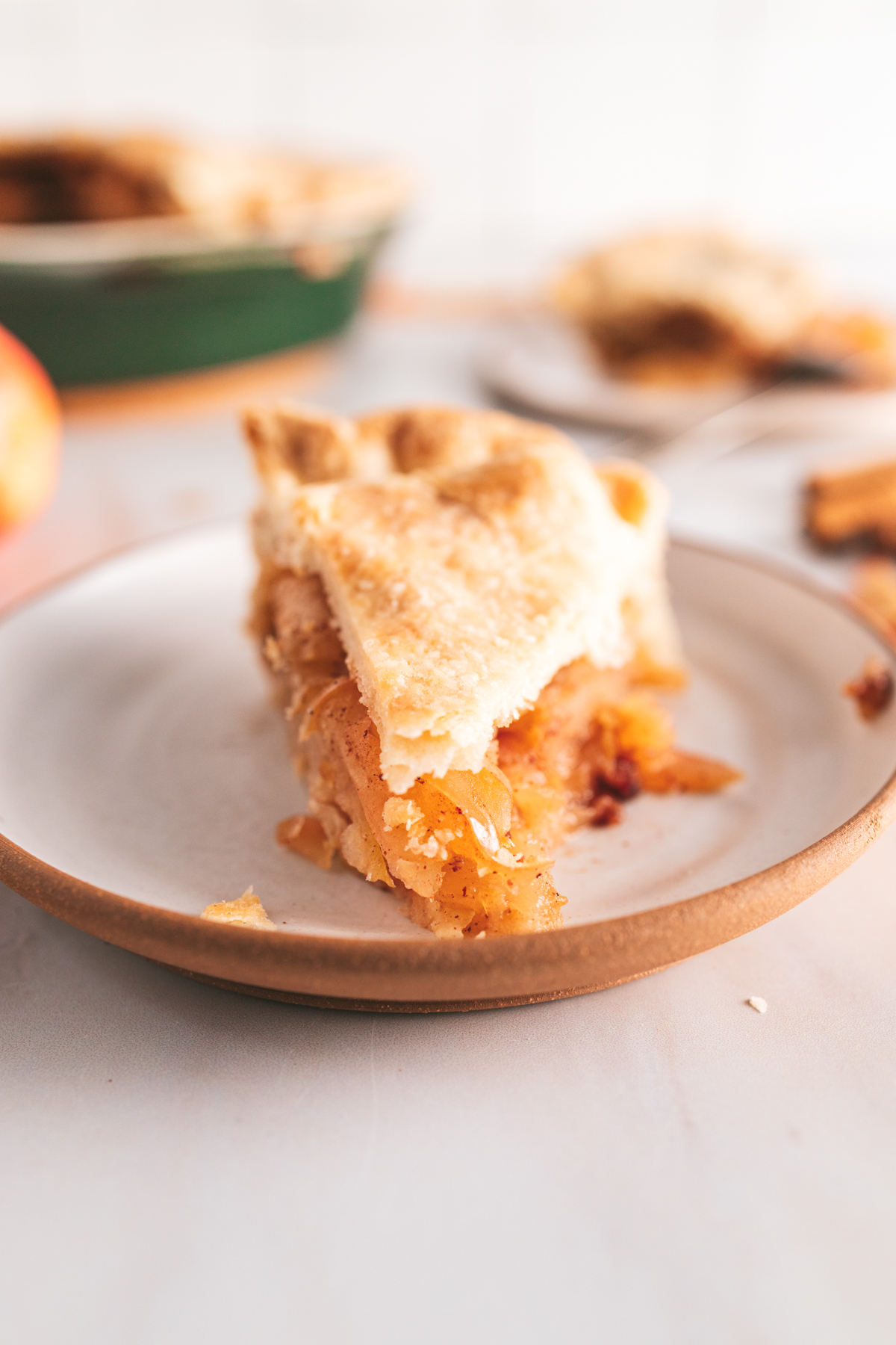 A slice of apple pie on a plate.