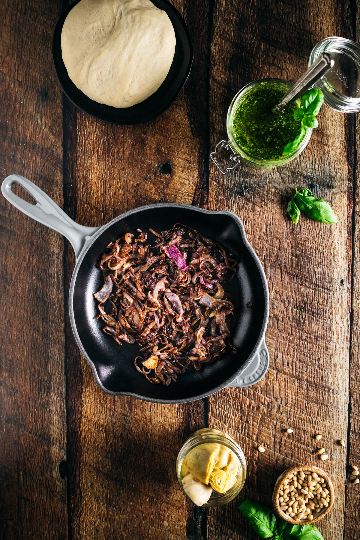 A frying pan with sauteed onion in it.