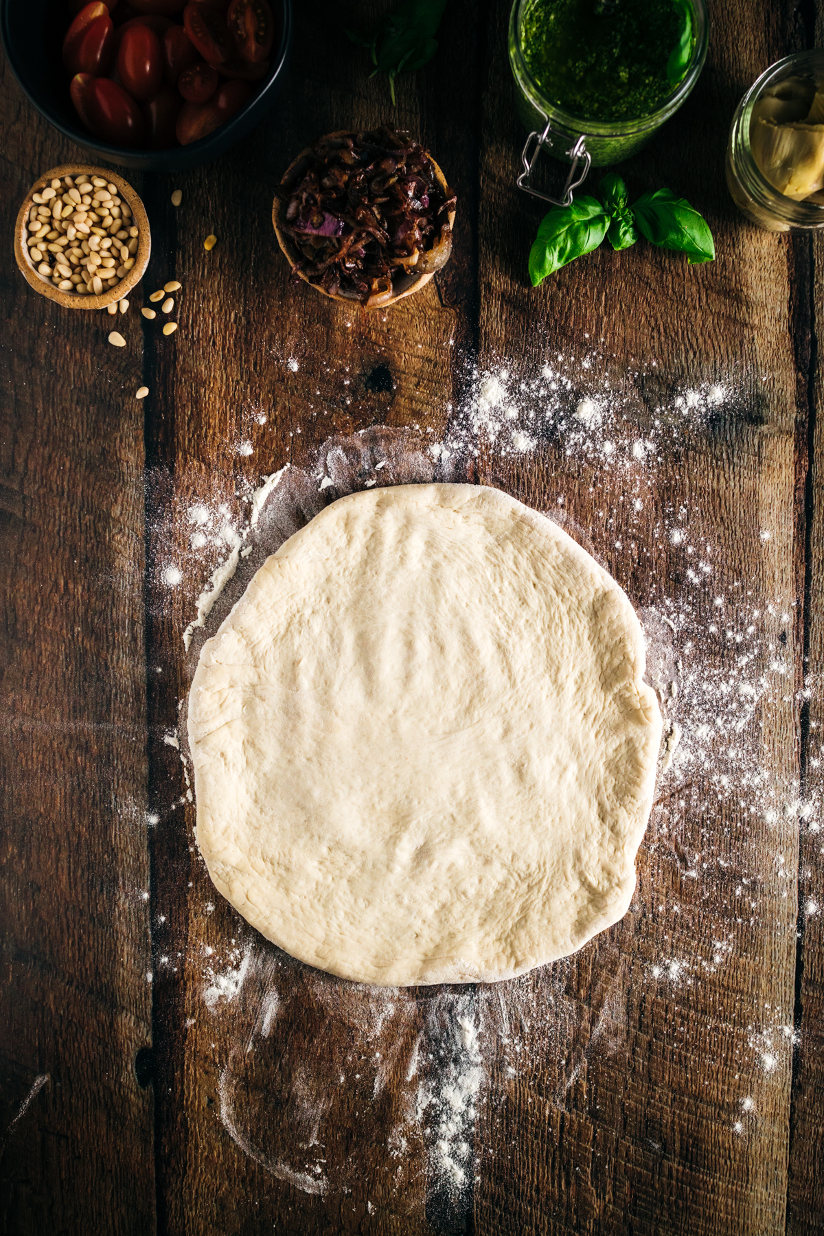 Dough for pizza on a wooden table.