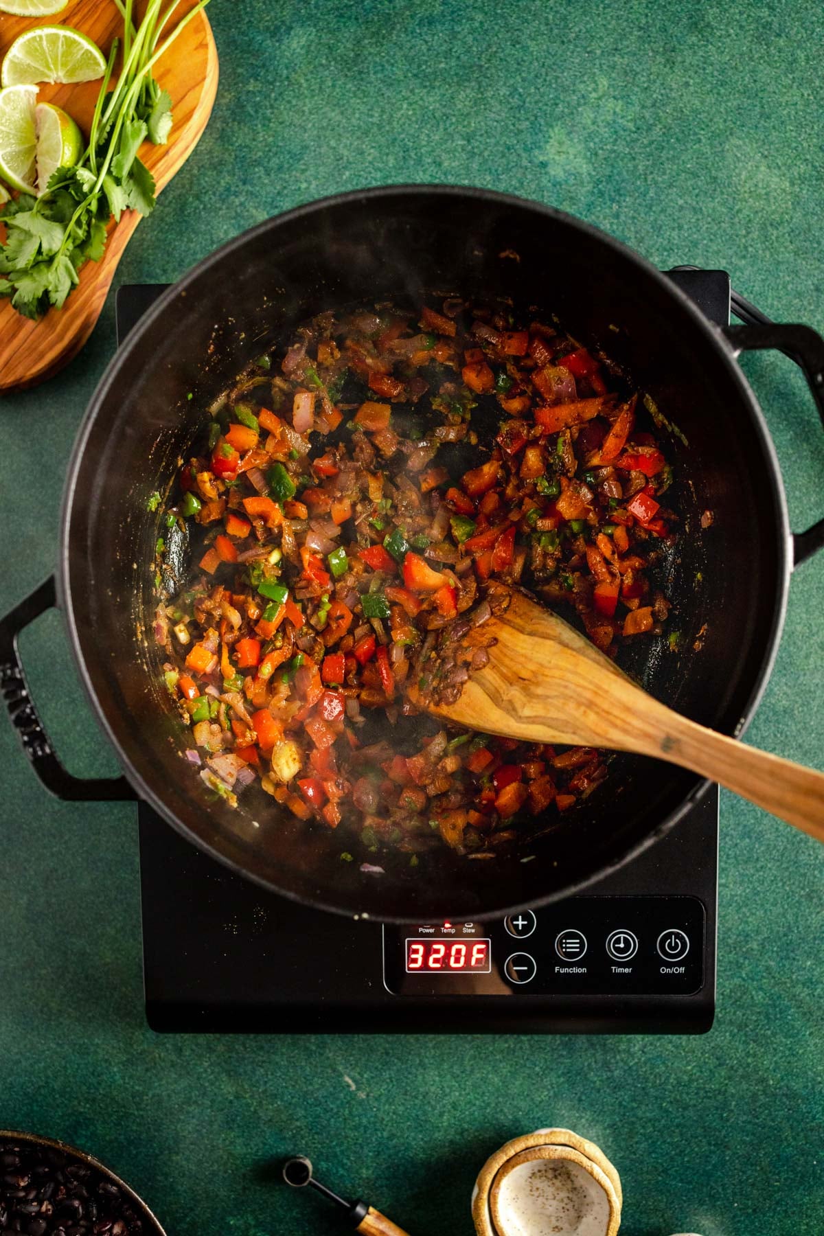A pot of food with a wooden spoon.
