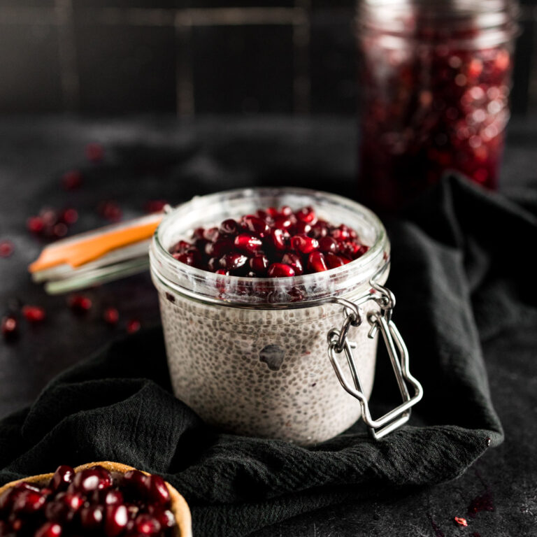 Chia seeds in a jar with pomegranate seeds.