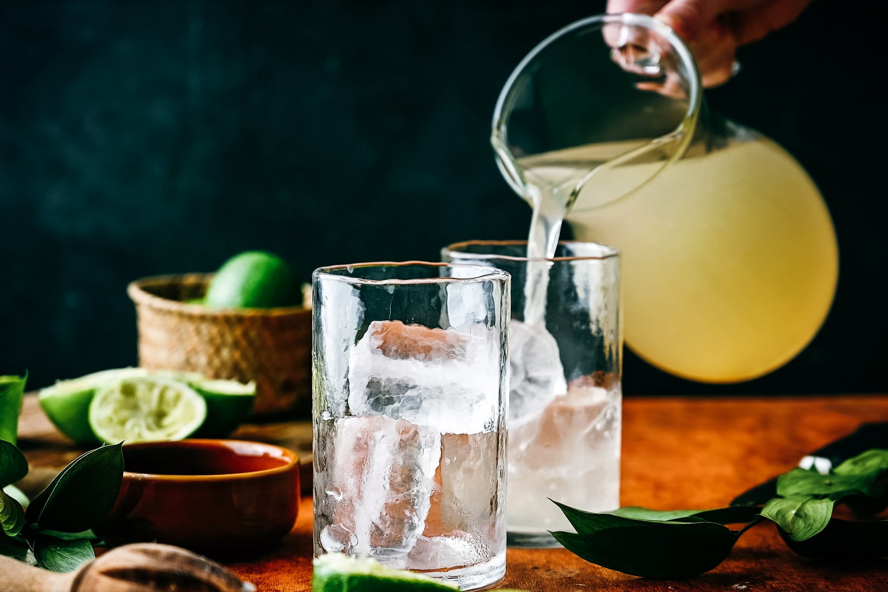 Pouring limeade into glasses.