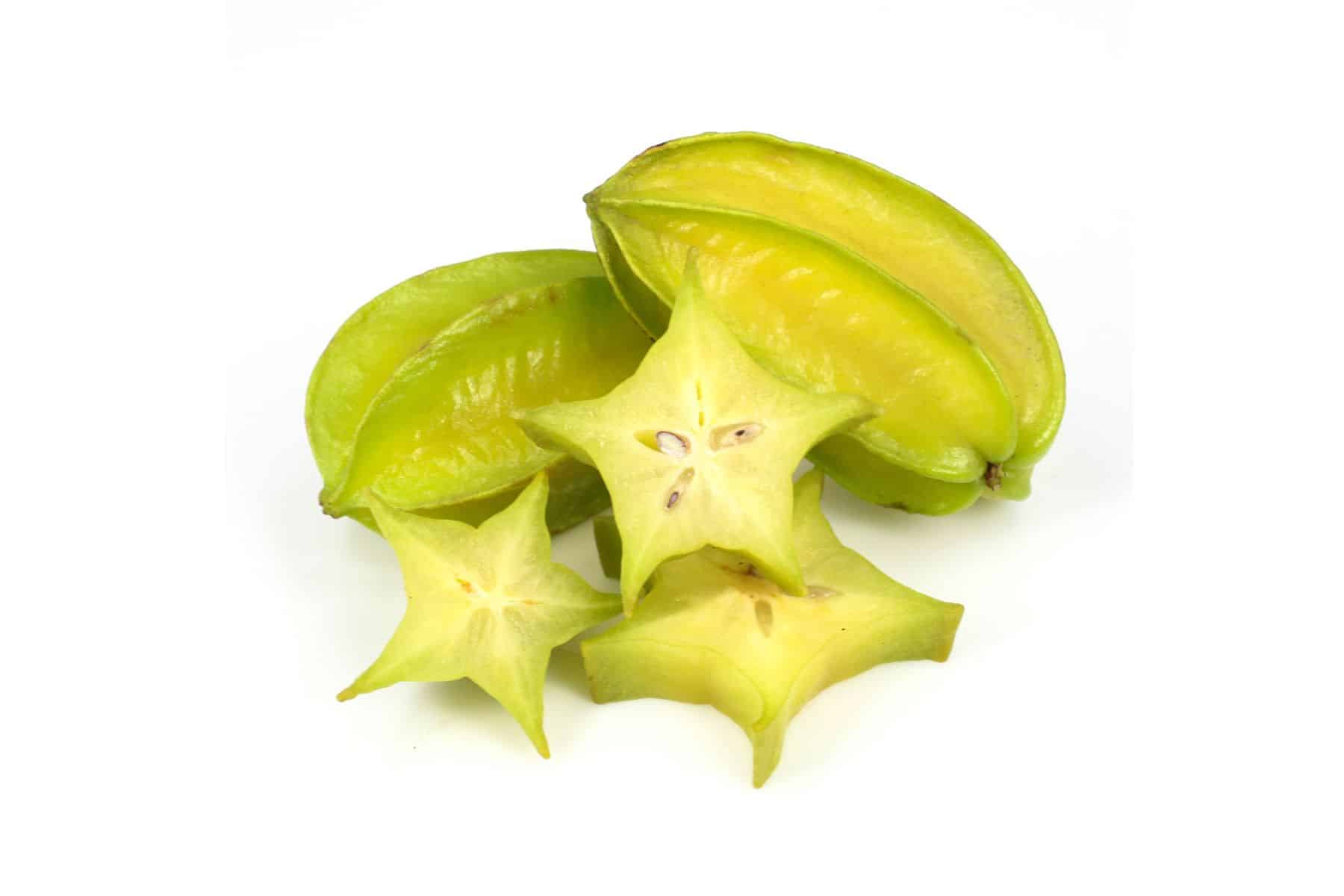Sliced and whole star fruits on a white background.