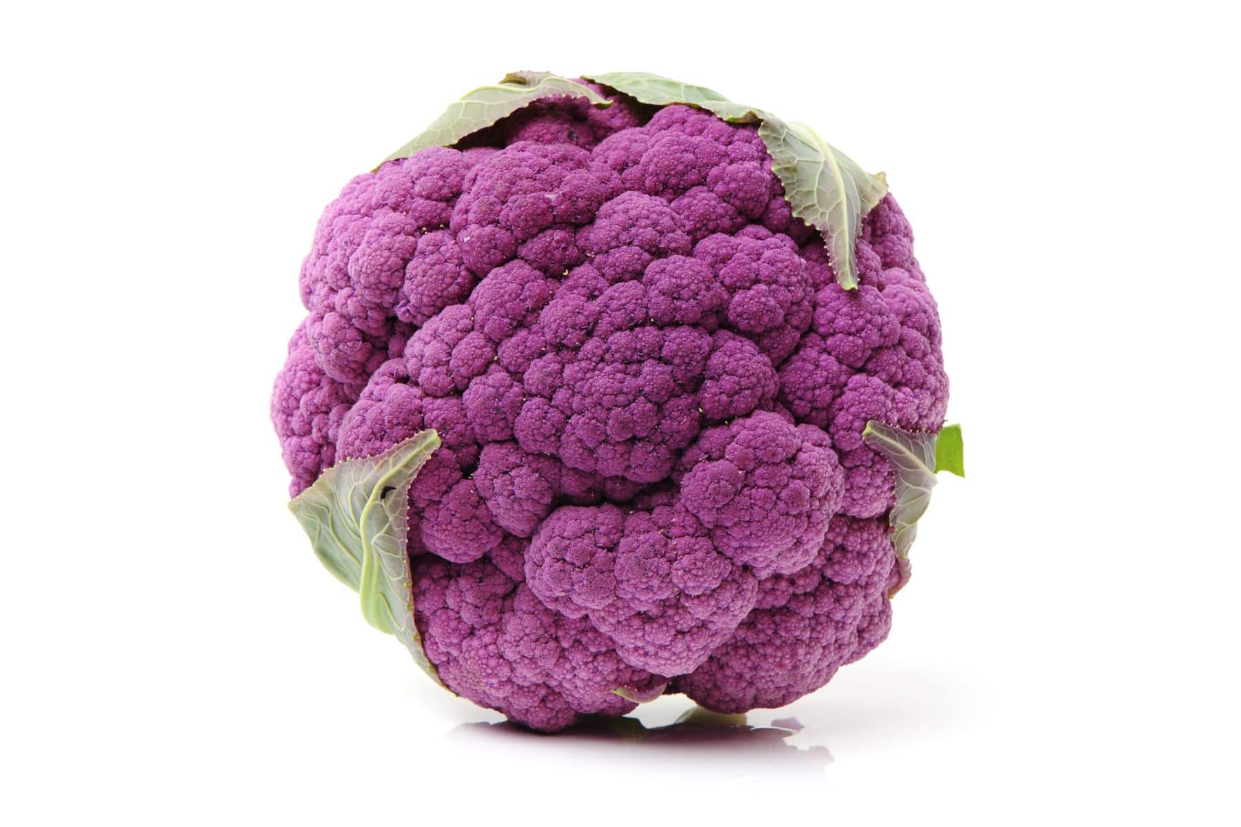 A purple cauliflower with green leaves, isolated on a white background.