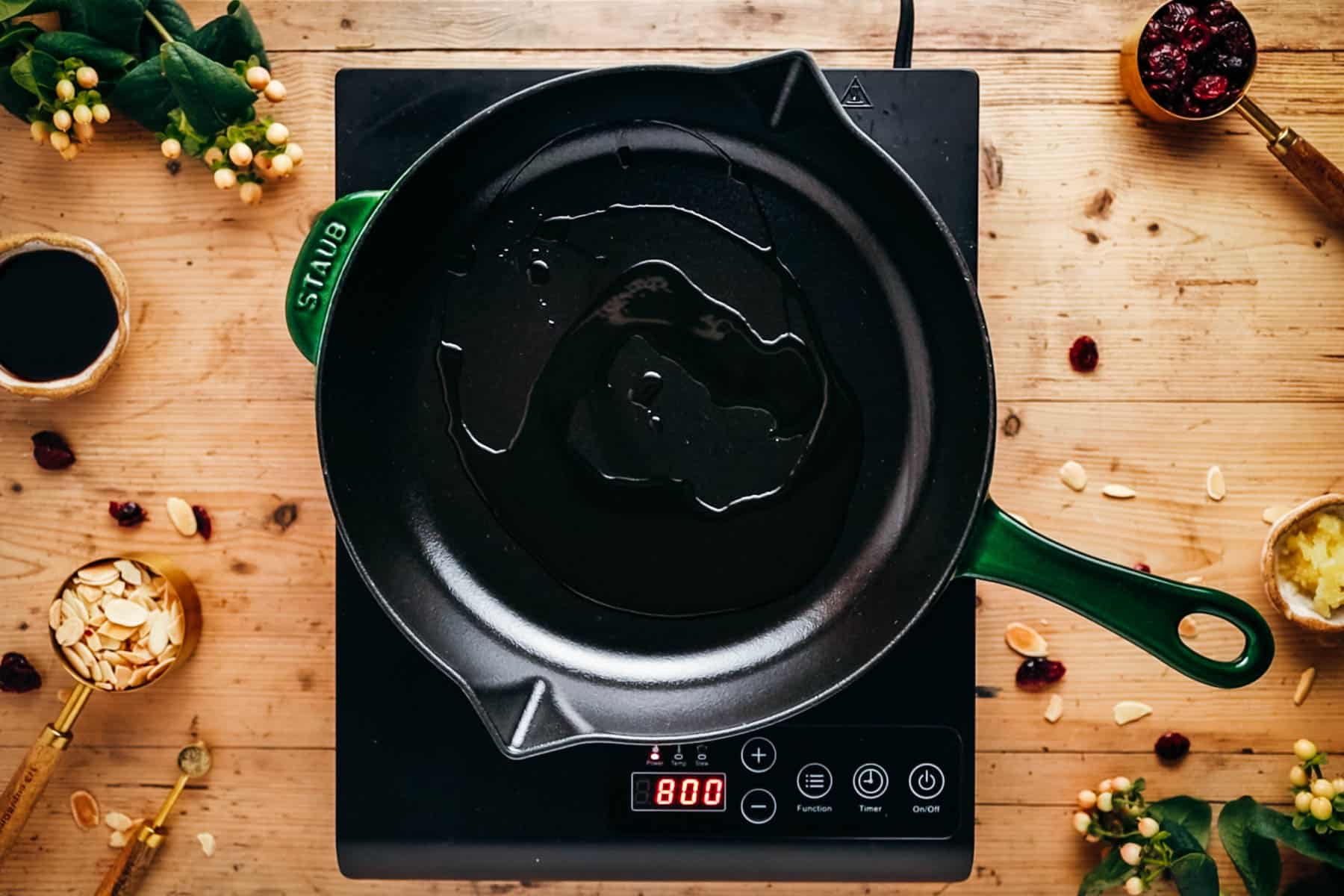 A black frying pan with oil sits on an electric stove.