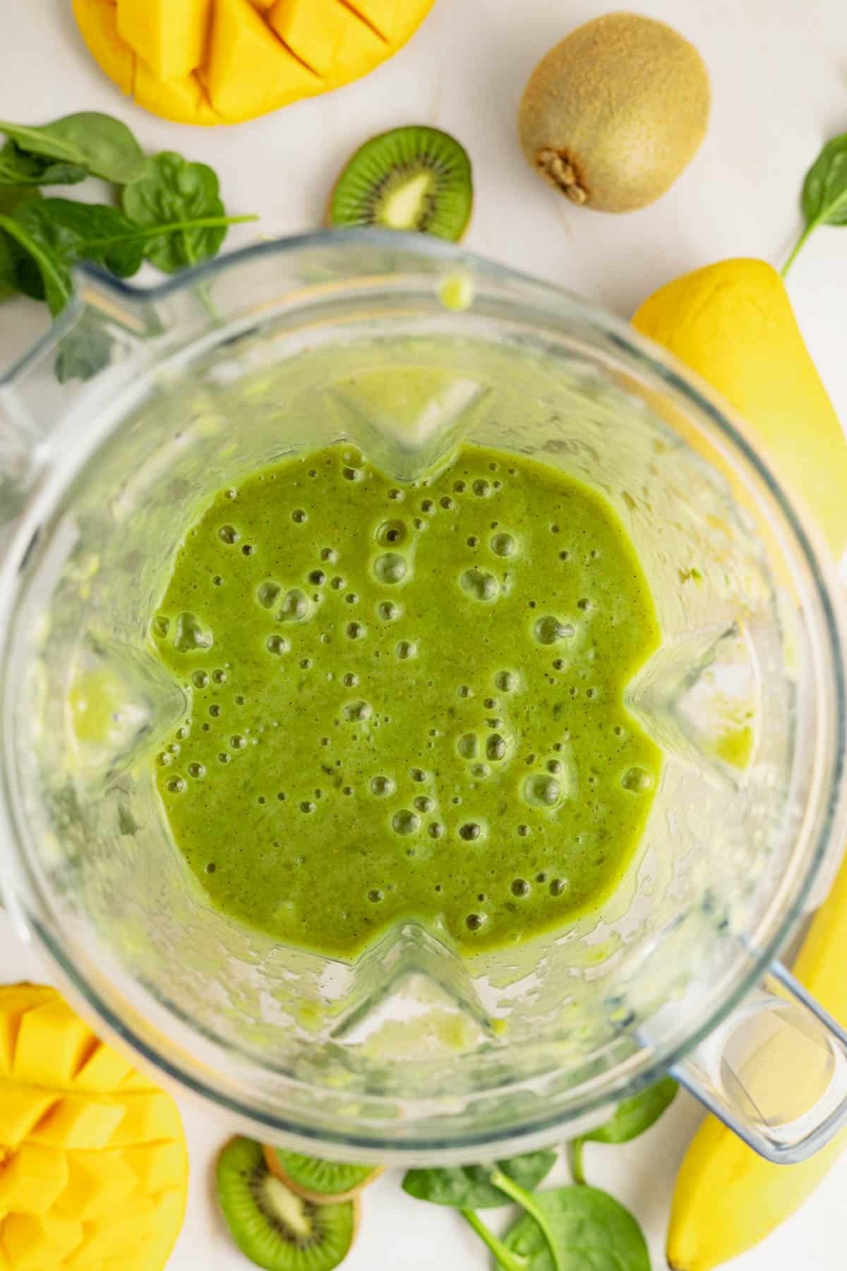 Blended green smoothie in a blender.
