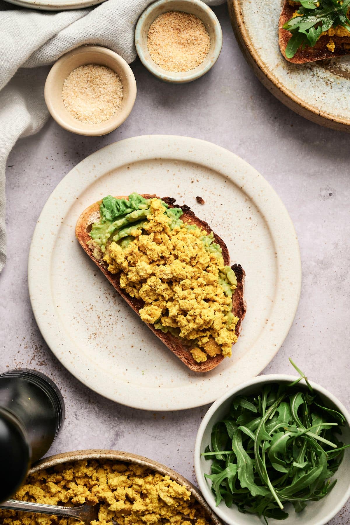 Protein toast with mashed avocado and vegan scrambled eggs.
