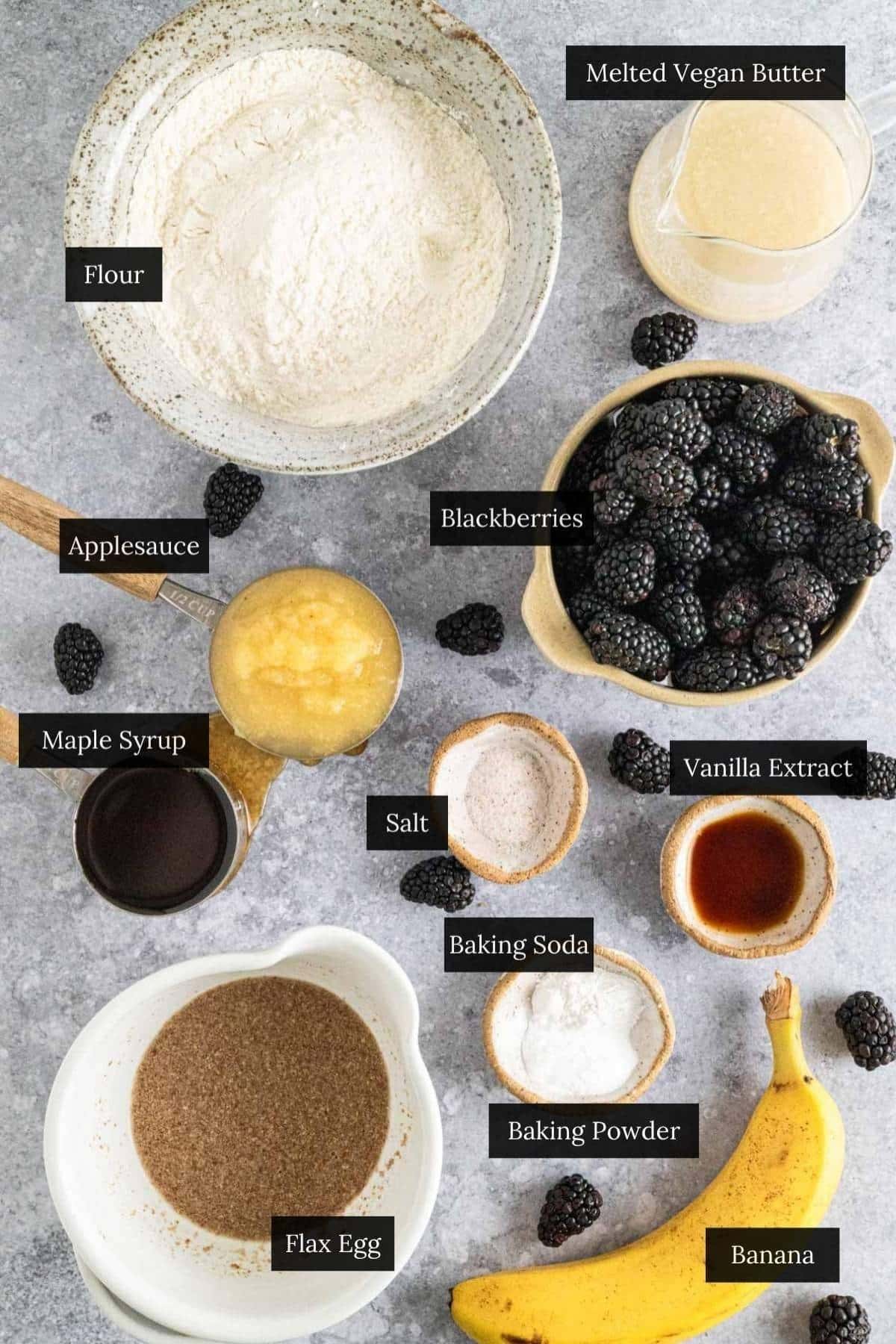 Ingredients for homemade vegan blackberry muffins with each ingredient labeled.