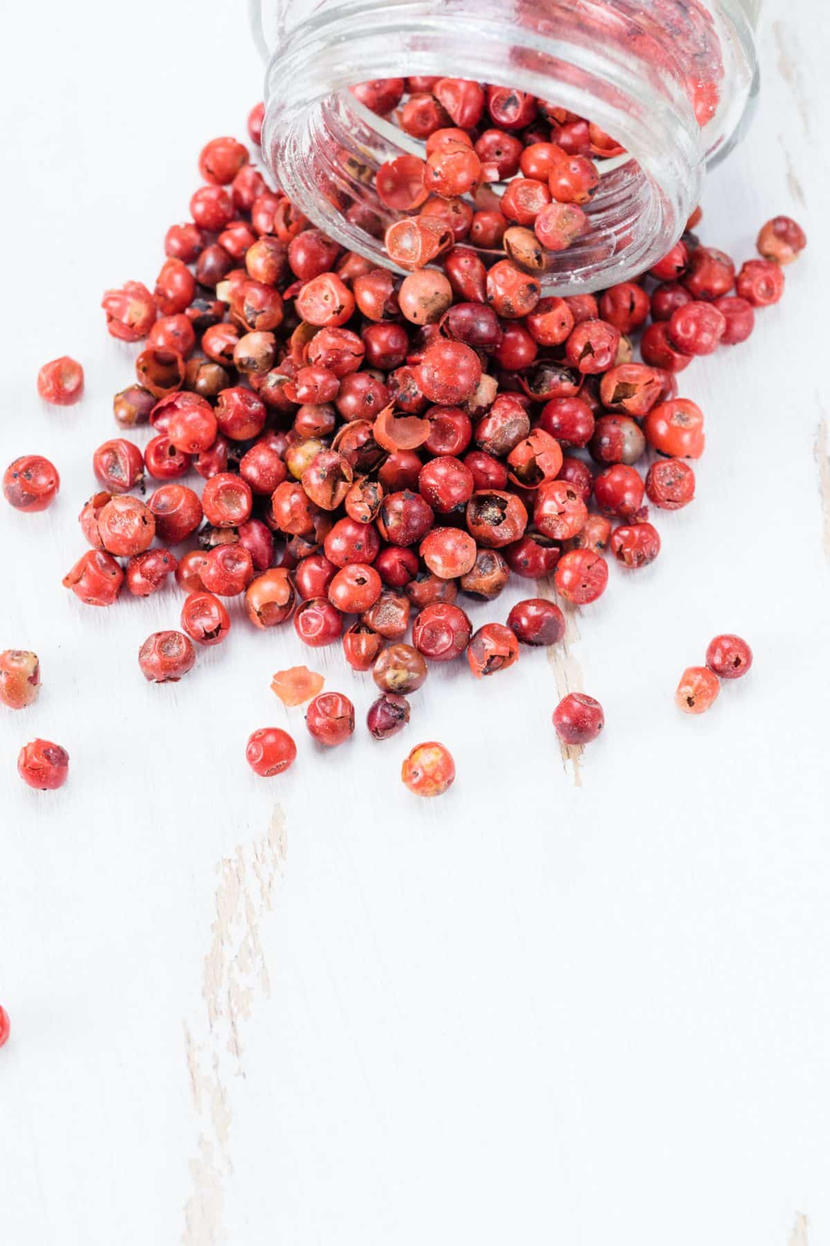 Jar of pink peppercorn tipped over.