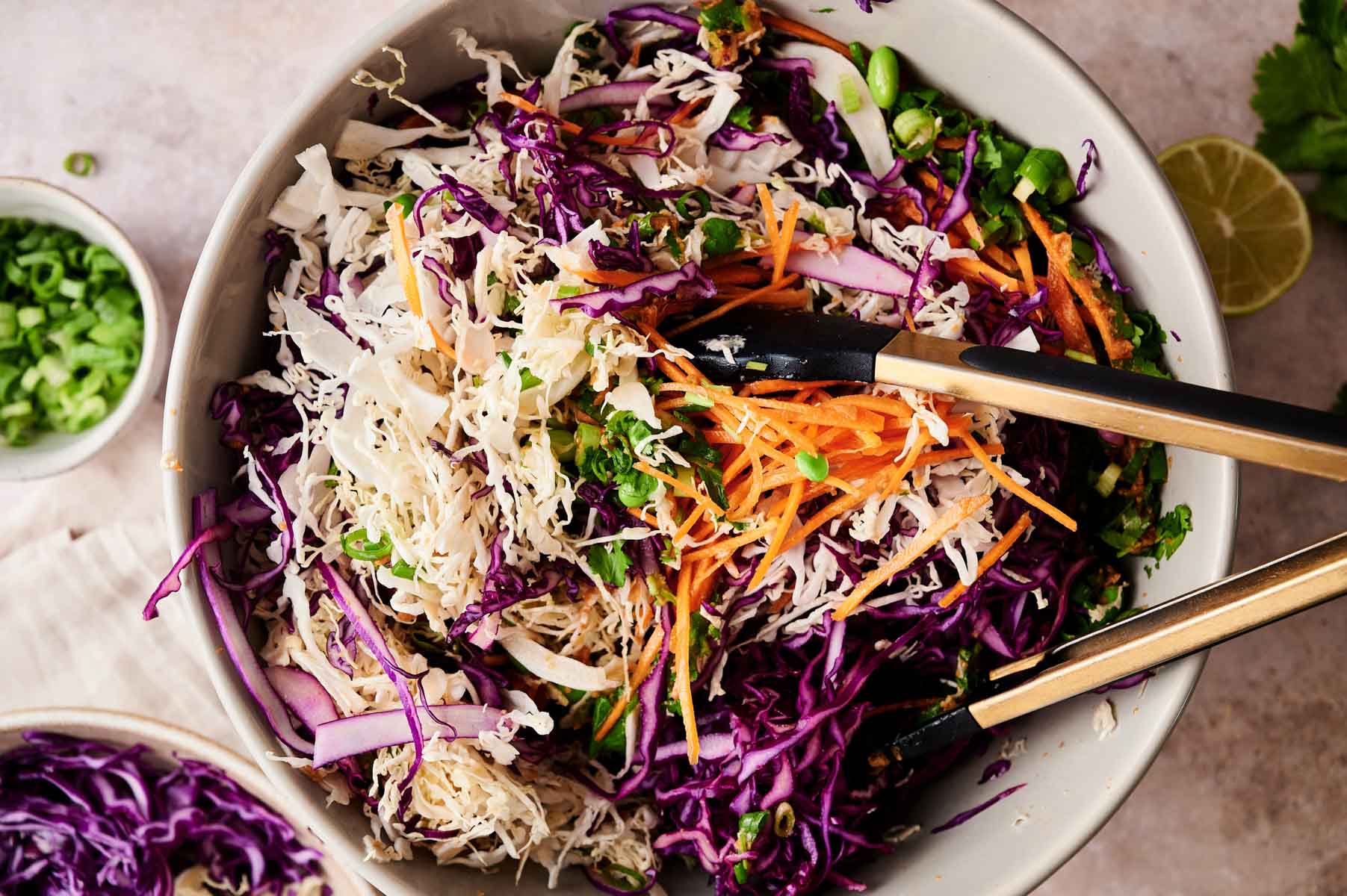 All of the ingredients for the spring salad being tossed and combined.
