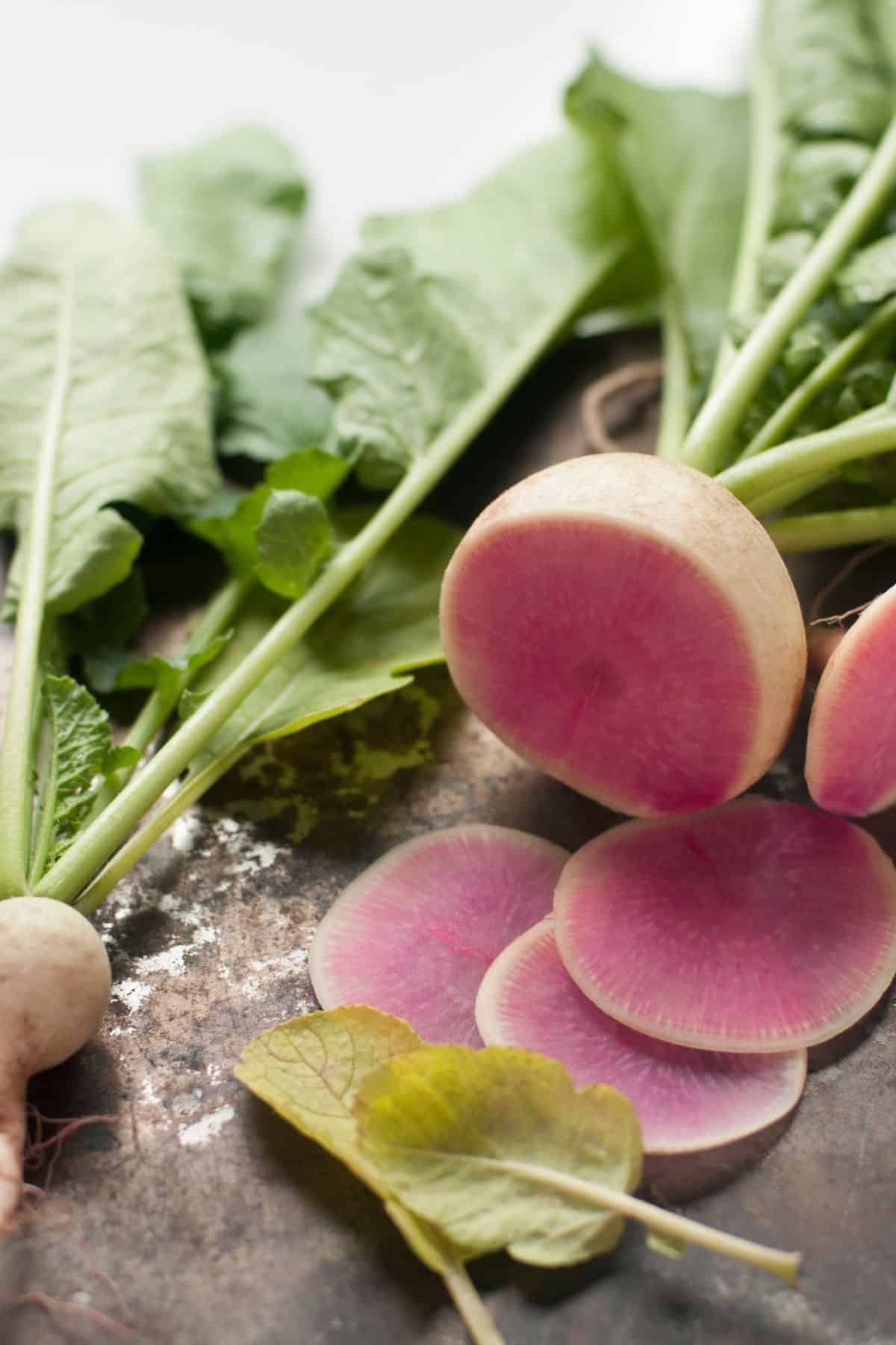 Radish with cream colored skin with pink inside. 