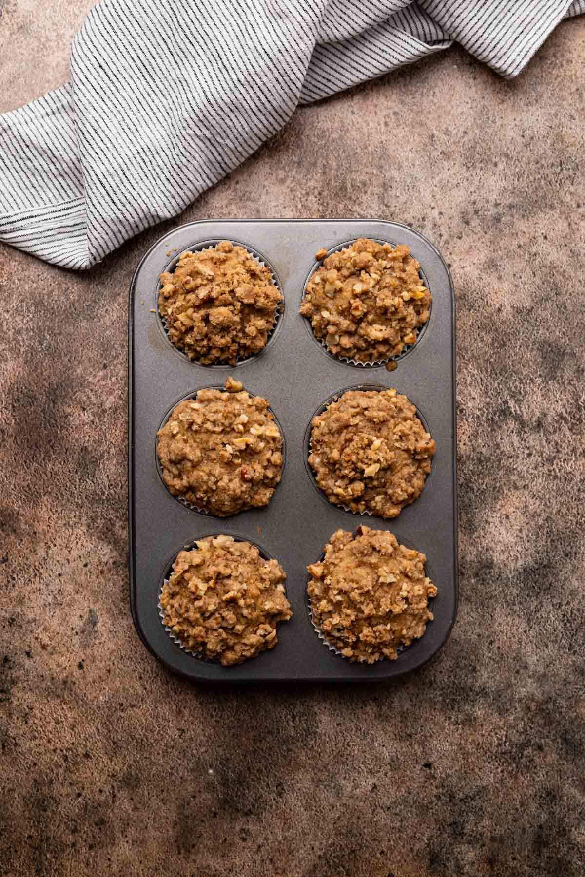 Muffins baked in a six tin muffin pan.