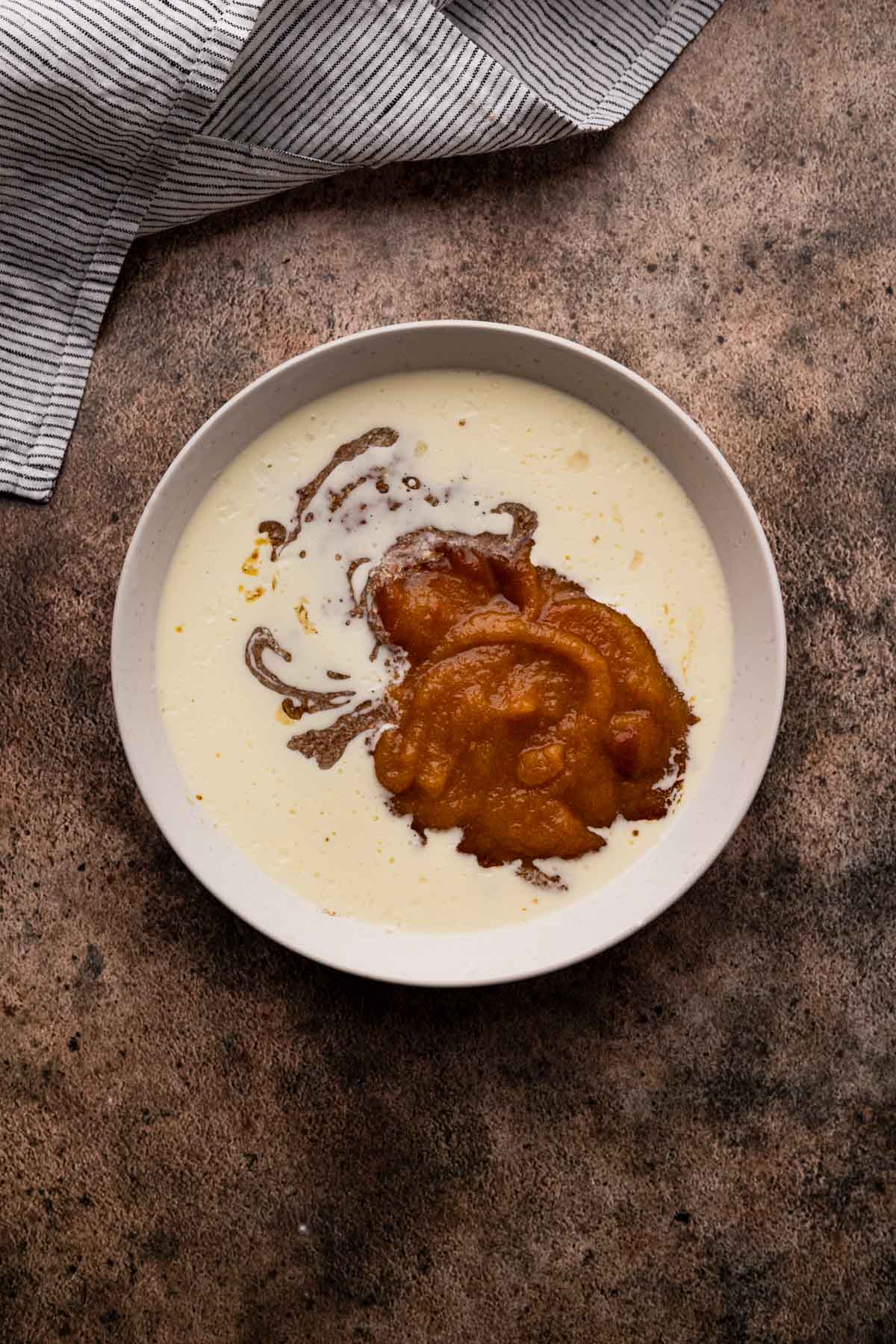 Combining the wet ingredients for banana pecan muffins.