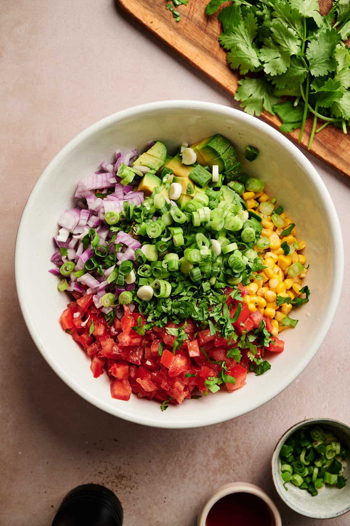 Ingredients for homemade Texas caviar with green onions on top.