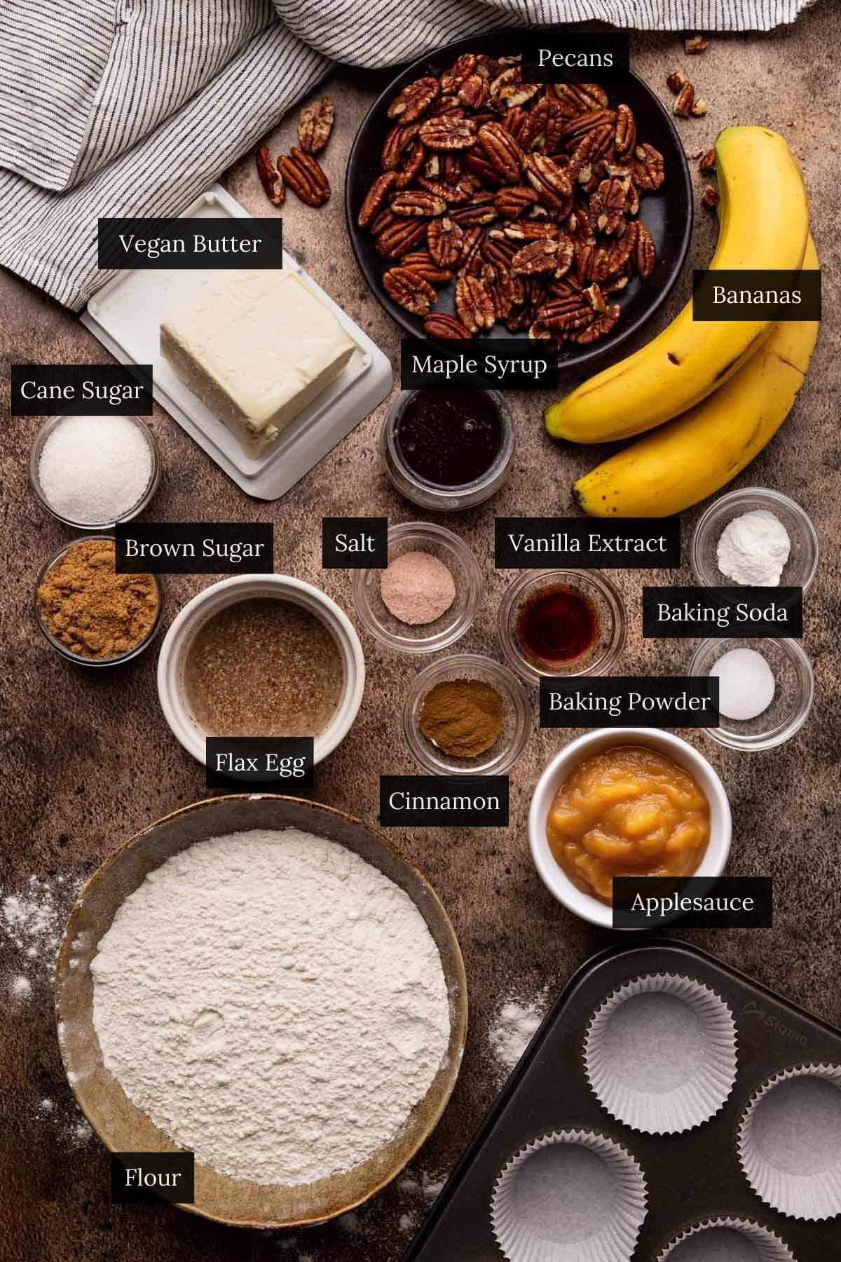 Ingredients for homemade banana pecan muffins with each ingredient labeled.
