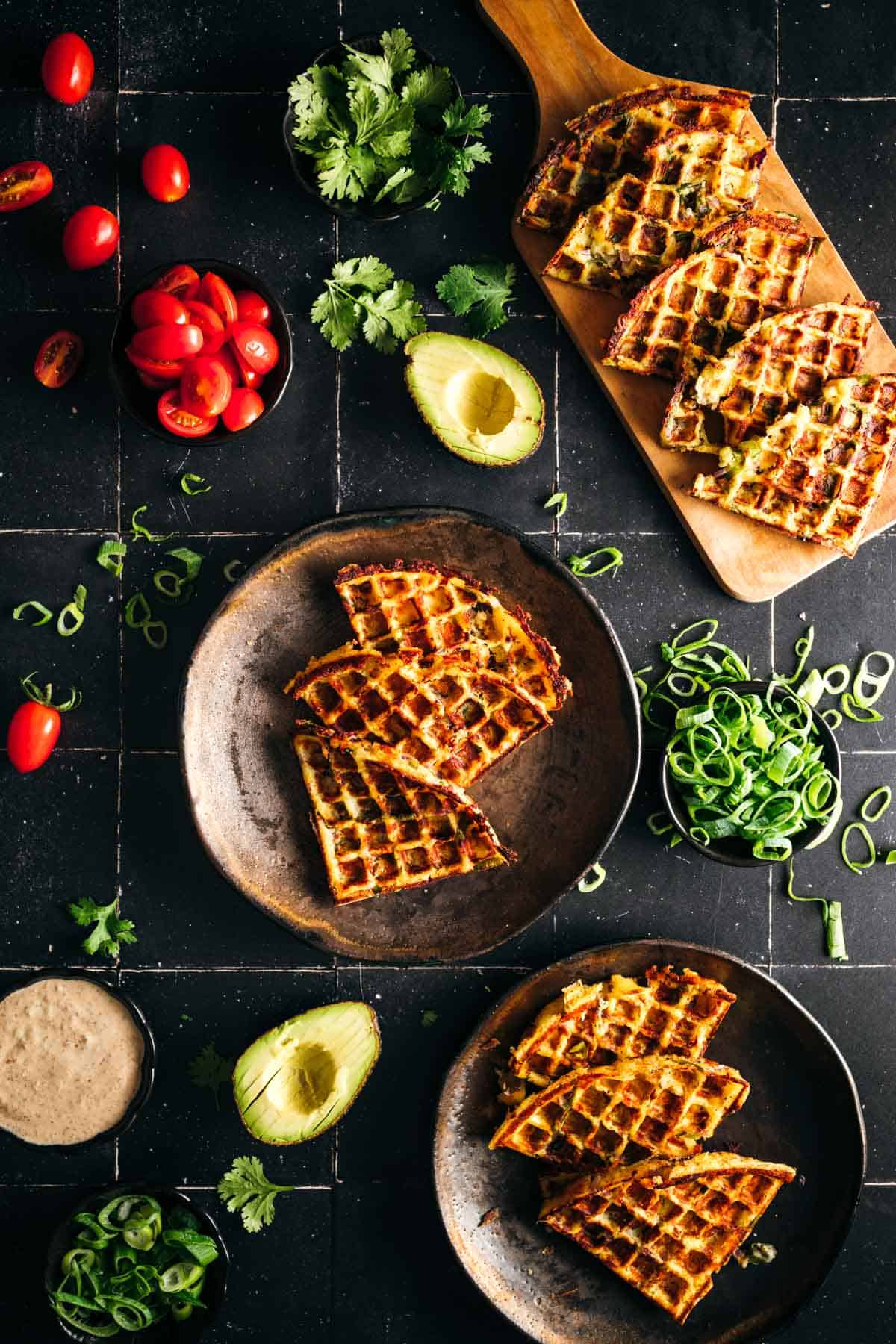 Waffles slices plated next to toppings.