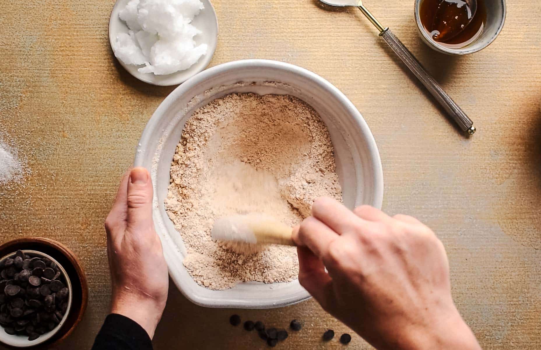 Dry ingredients for pumpkin cookies added to a large mixing bowl.