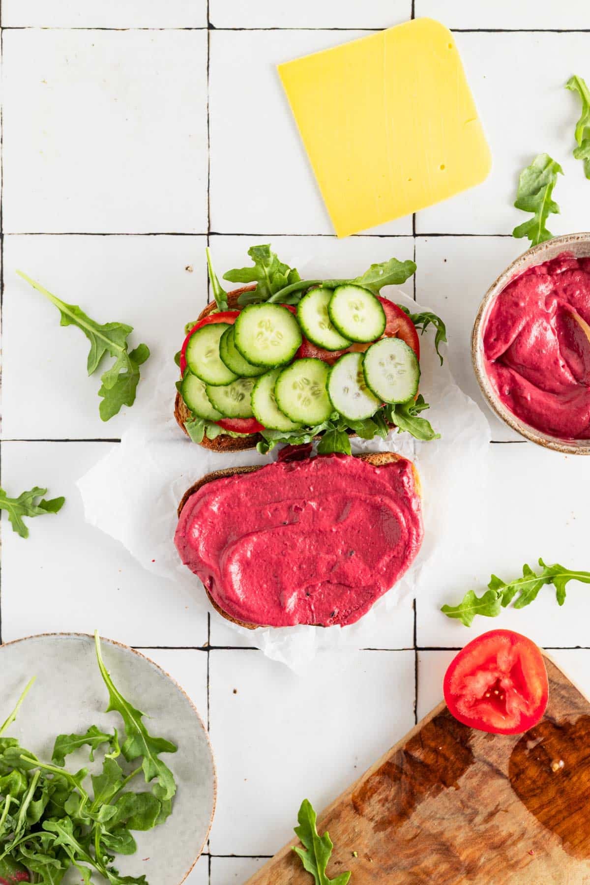 Adding veggies to a vegetable beetroot sandwich.
